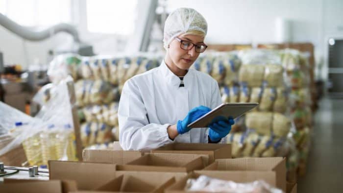 Highly trained quality control technician inspecting products in manufacturing facility.