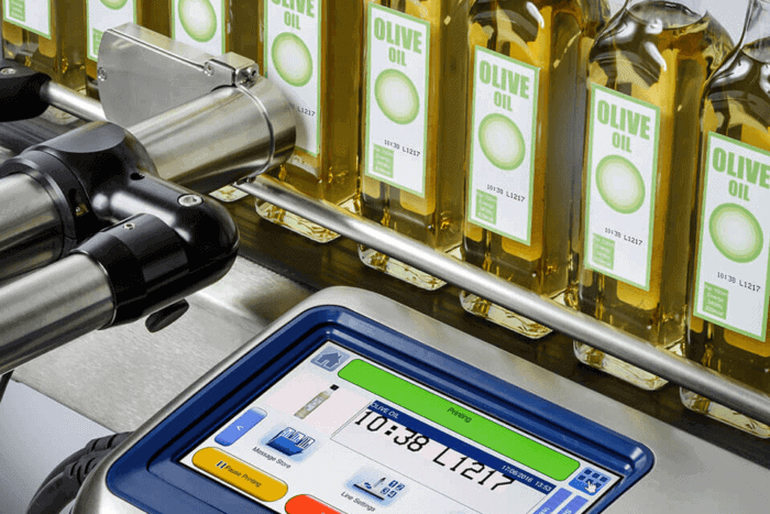 Bottle filling machine for olive oil production at Factronics USA.