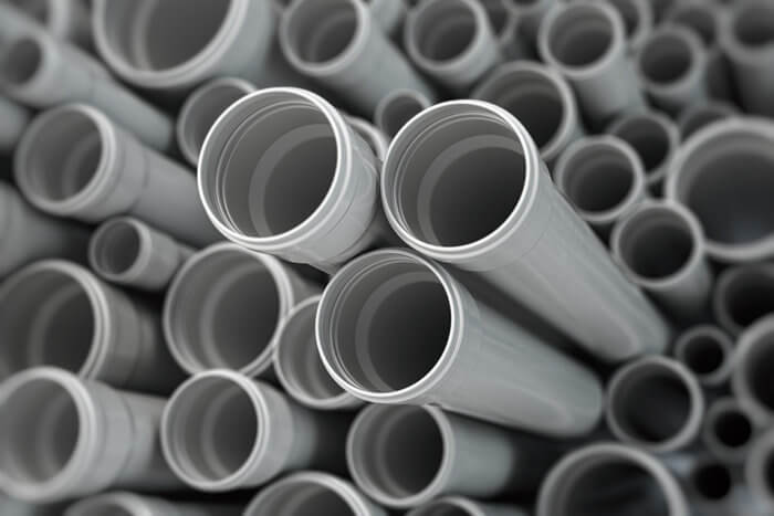 PVC pipes stacked, plumbing supply pipes for industrial and residential use.