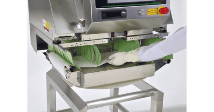 Automated medical device packaging machine for sterile wrapping and sealing.