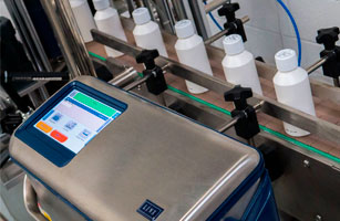 Linx 10. Factory automation equipment for precise liquid filling and capping processes.