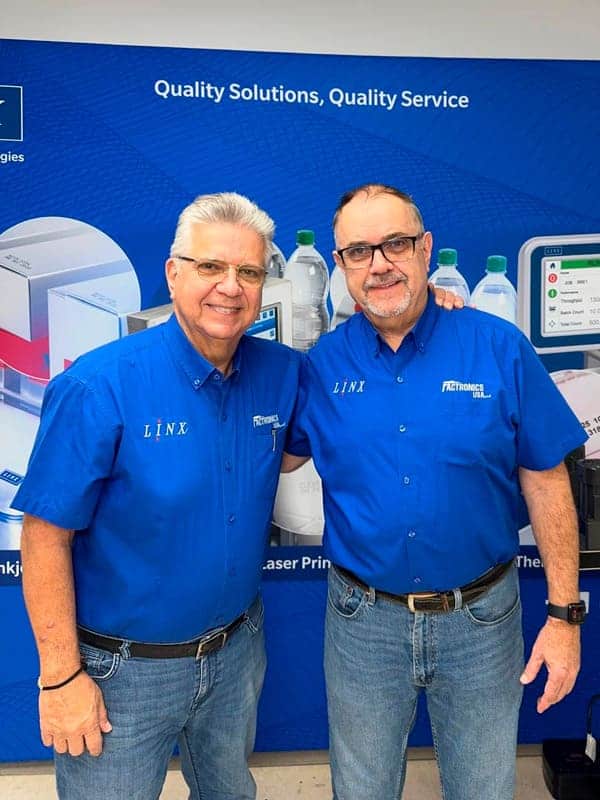 High-quality electronics service technicians at Factronics USA in matching blue uniforms.