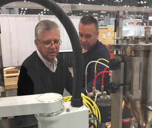 High-tech industrial machinery at a trade show, showcasing manufacturing automation equipment.