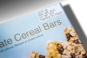 Precision food labeling sticker on cereal bar packaging for quality control.